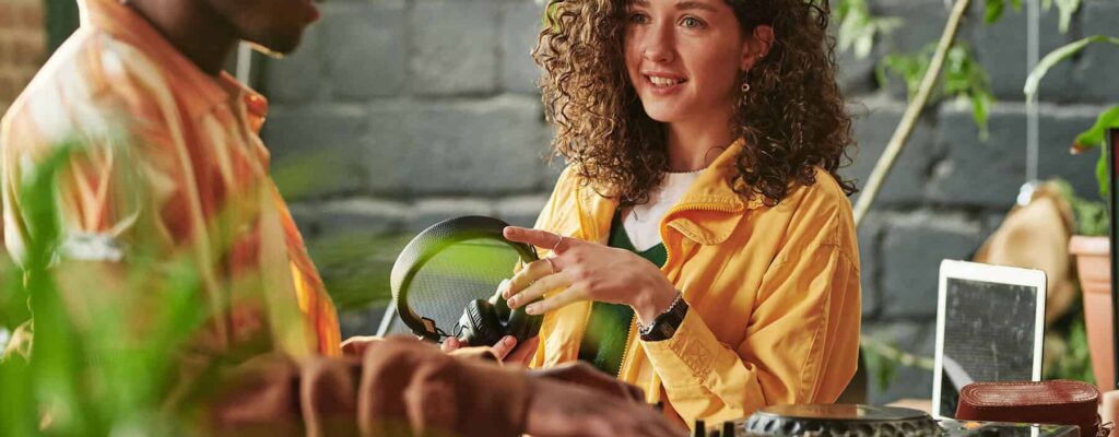 Famous DJ Agency - Support Local Musicians -girl-with-headphones-in-hands-looking-at-h-2023-11-27-05-14-56-utc Famous DJ Agency - Support Local Musicians